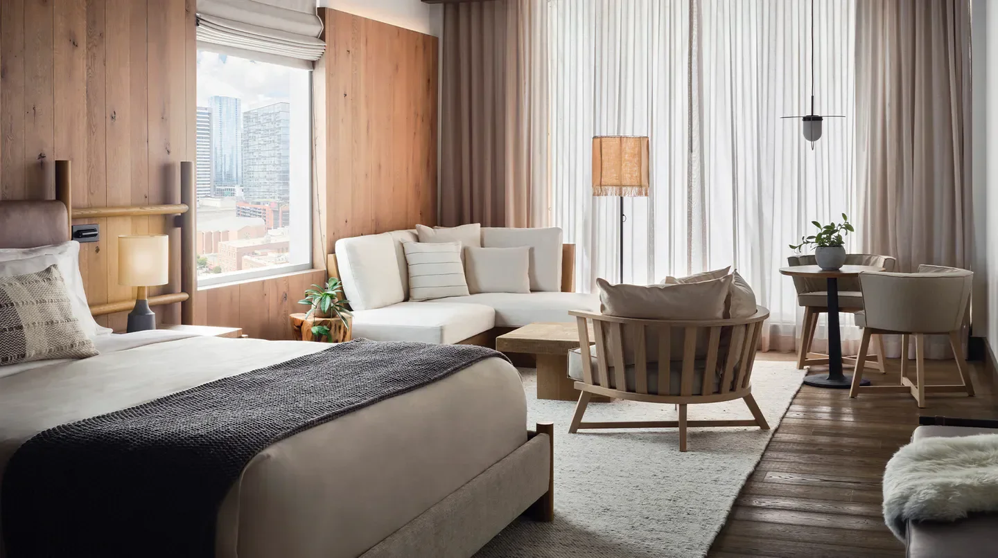 Stylish hotel room at 1 Hotel Nashville, featuring views of Nashville's skyline.
