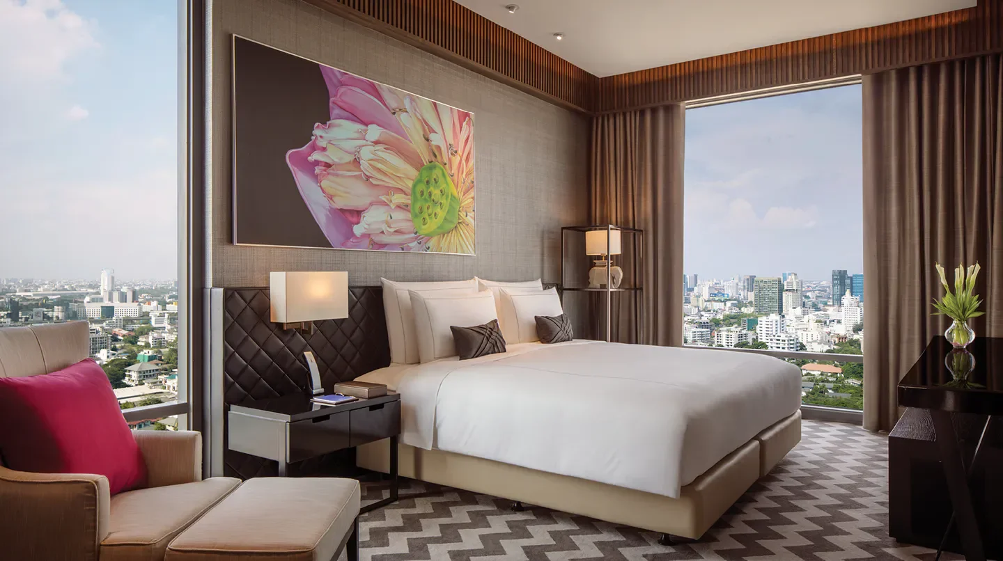 Luxury bedroom at 137 Pillars Suites & Residences Bangkok with city view of Bangkok.