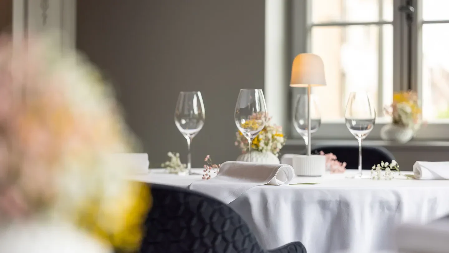 Elegant dining table at 1741 Restaurant in Strasbourg, featuring wine glasses and decor.