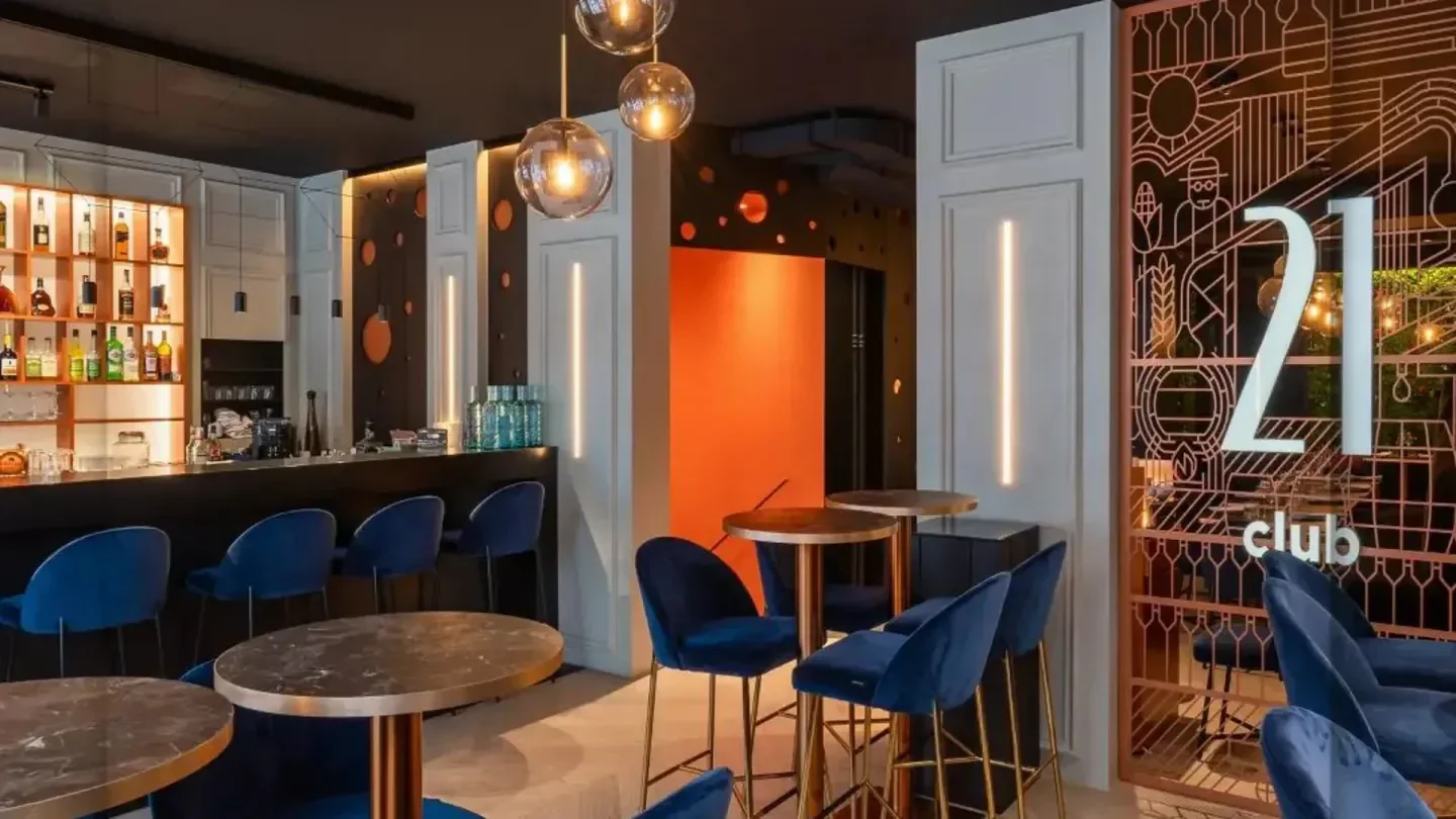 Interior of the 21 Club in Geneva with stylish blue chairs and bar.