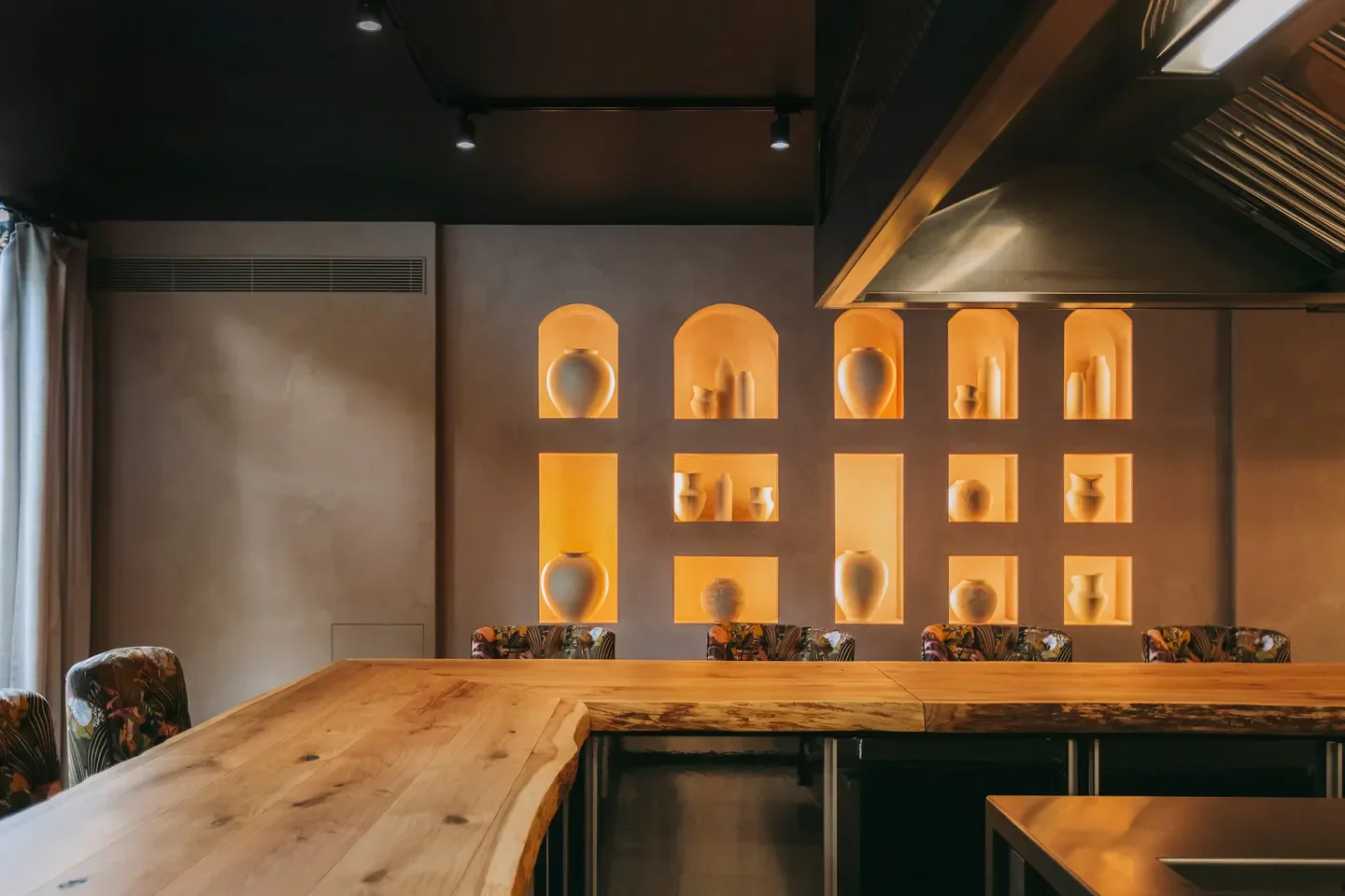 Interior of 2Monkeys in Lisbon. Restaurant with wooden counter and unique decorative niches.