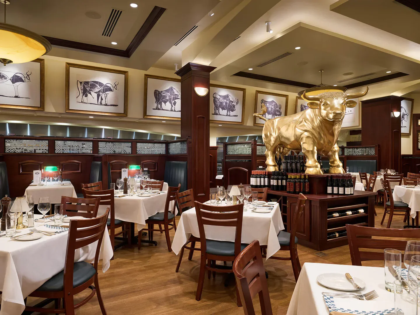 Interior of 801 Chophouse in Kansas City, Missouri, featuring bull statue and dining tables.