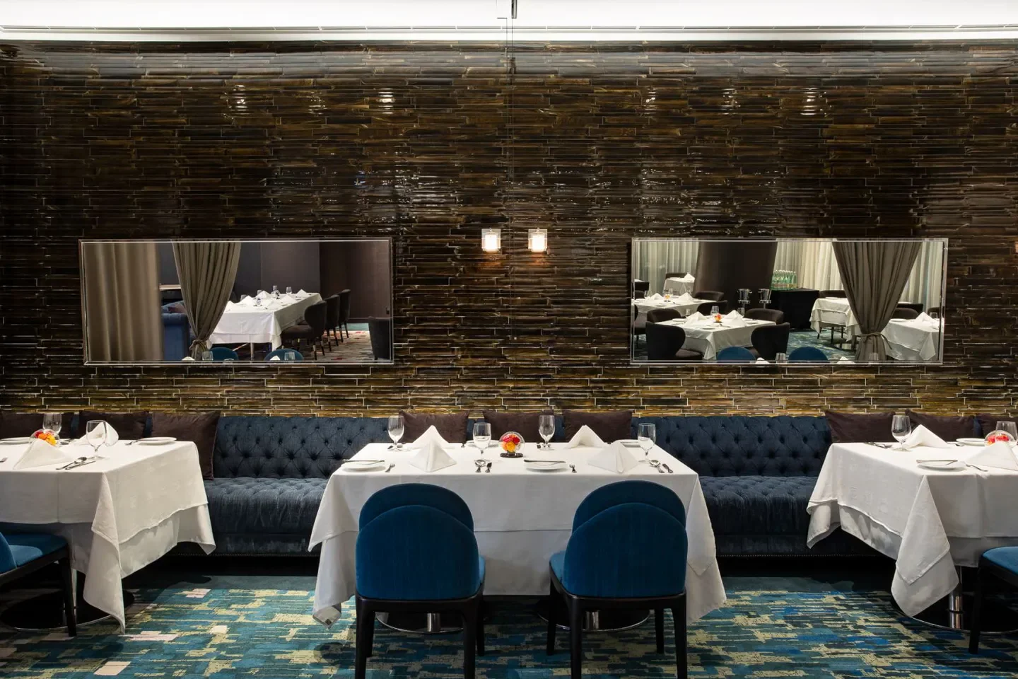 Elegant dining room interior at A Cut restaurant in Taipei with mirrored accents.