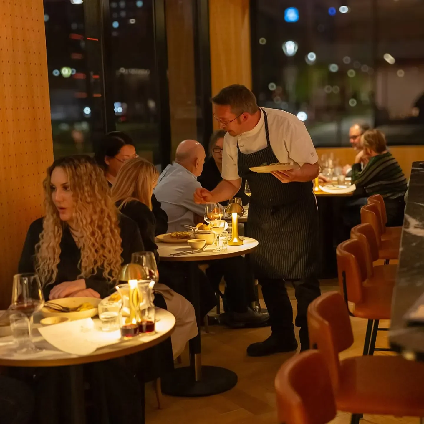 Chef serving at A Prayer for the Wild at Heart in Adelaide, restaurant interior with guests.