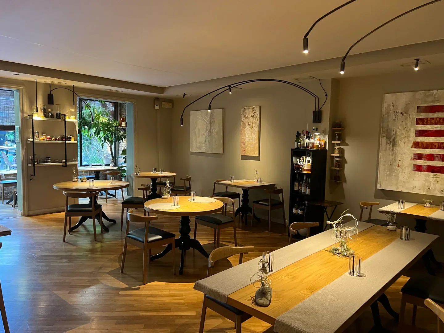 Cozy dining room at Abocar Due Cucine restaurant in Emilia-Romagna, featuring tables and art.