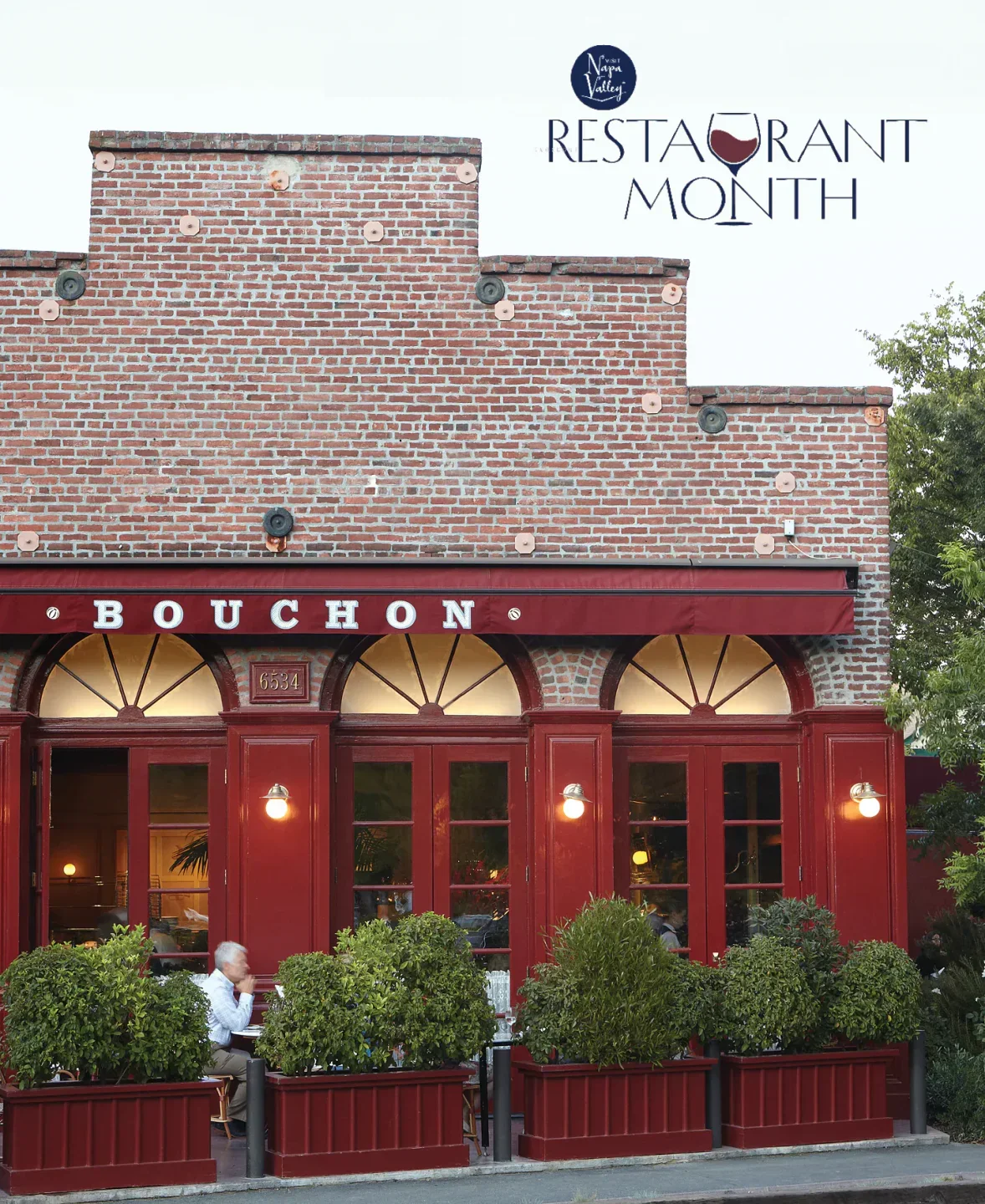 Exterior of Addendum at Ad Hoc restaurant in Napa Valley with red doors and patio seating