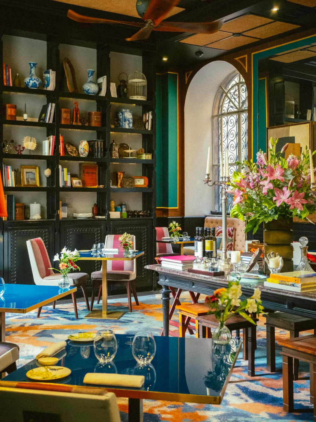 Elegant restaurant interior in Adelaide featuring colorful patterned carpets and bookshelves.