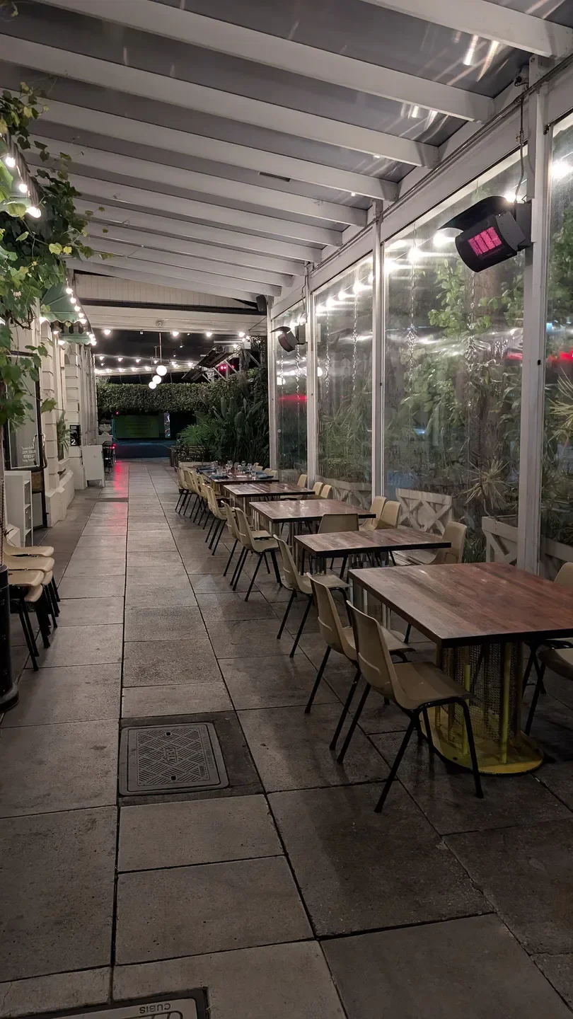 Outdoor seating at Africola restaurant in Adelaide, with tables set for dining.