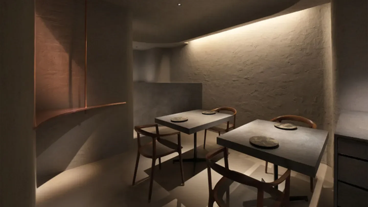 Interior of Agnel d'Or restaurant in Osaka, showcasing minimalist design and elegant dining space.