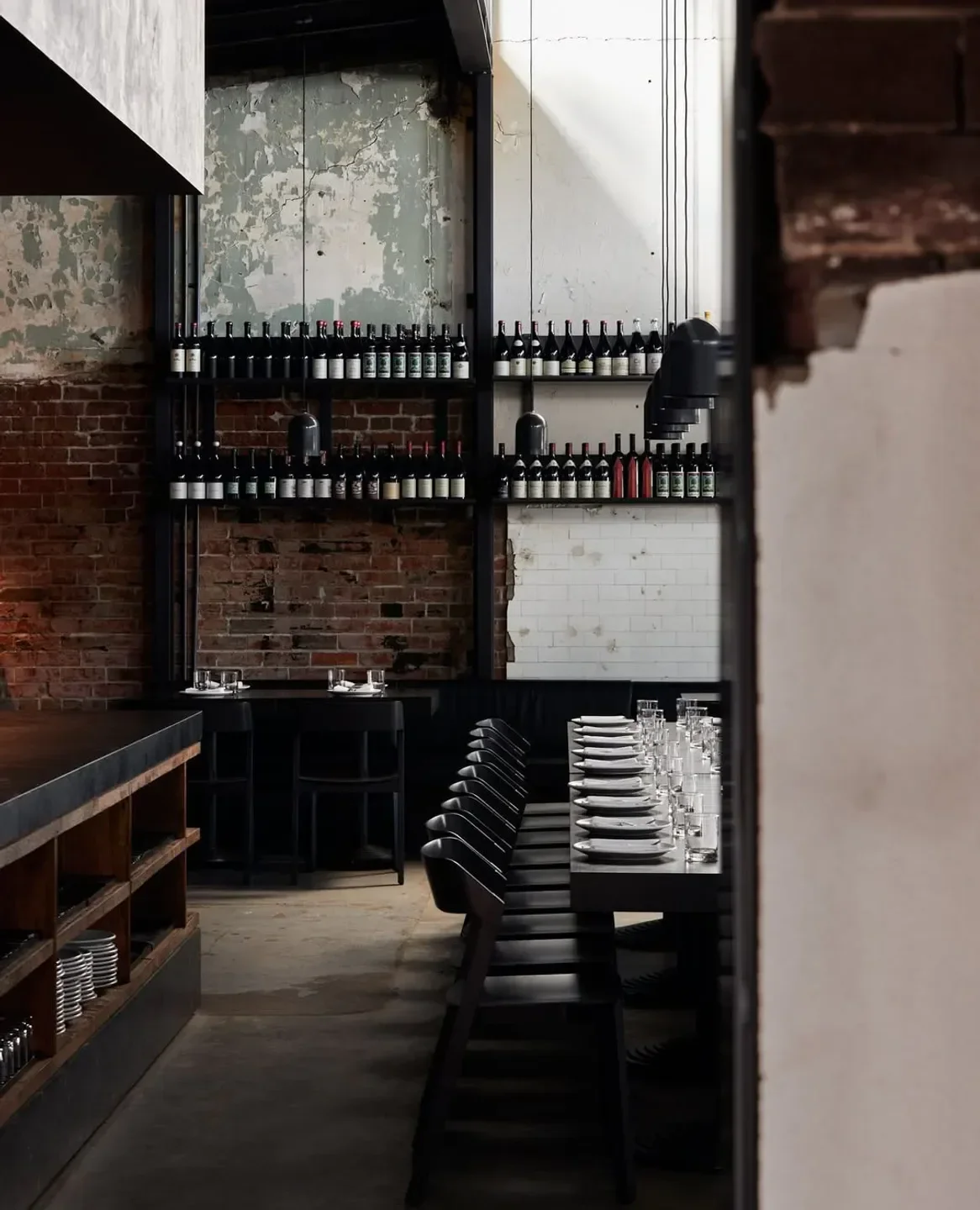 Interior of Agnes Restaurant in Brisbane, showcasing rustic brick walls and wine display.