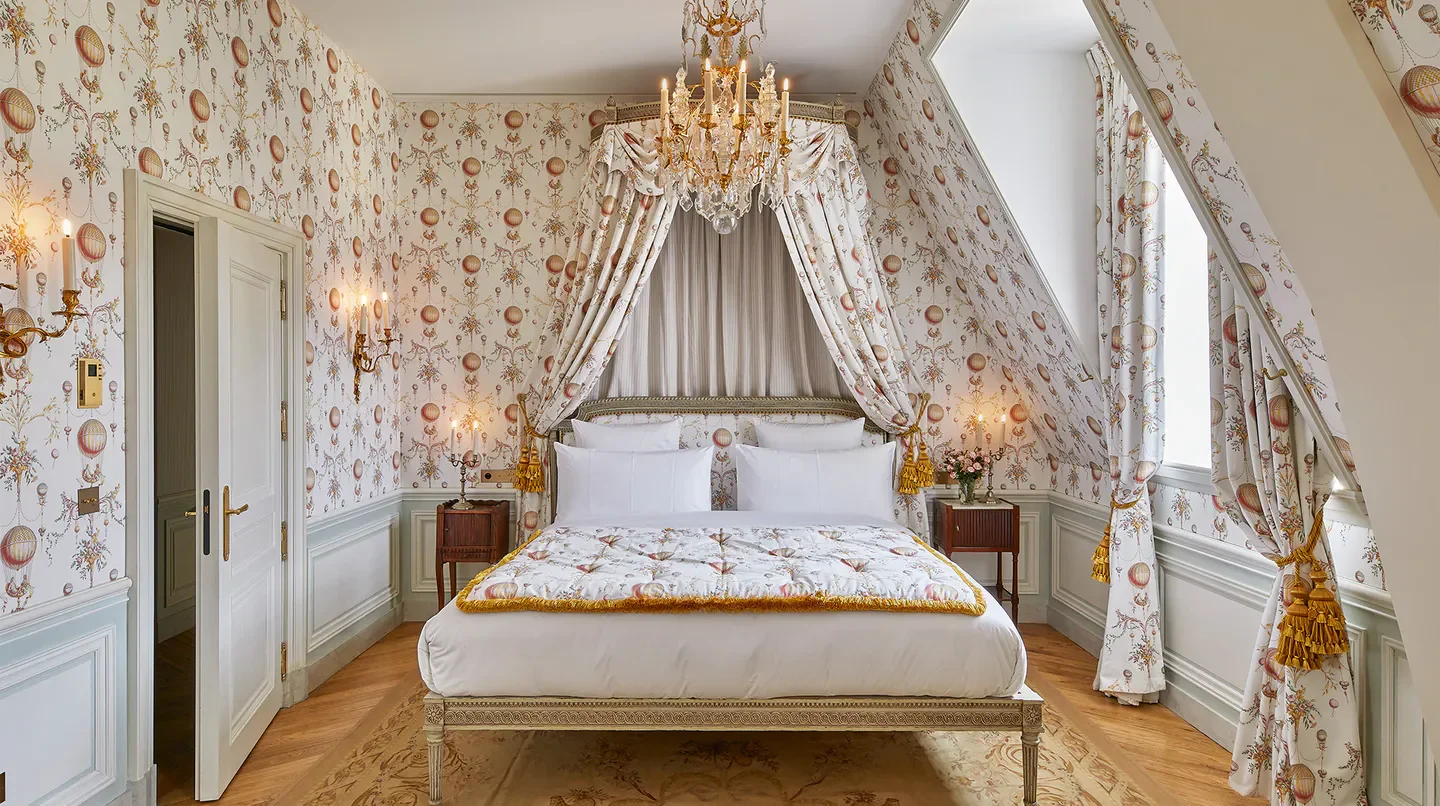 Elegant bedroom at Airelles Château de Versailles, Le Grand Contrôle in Paris with canopy bed.