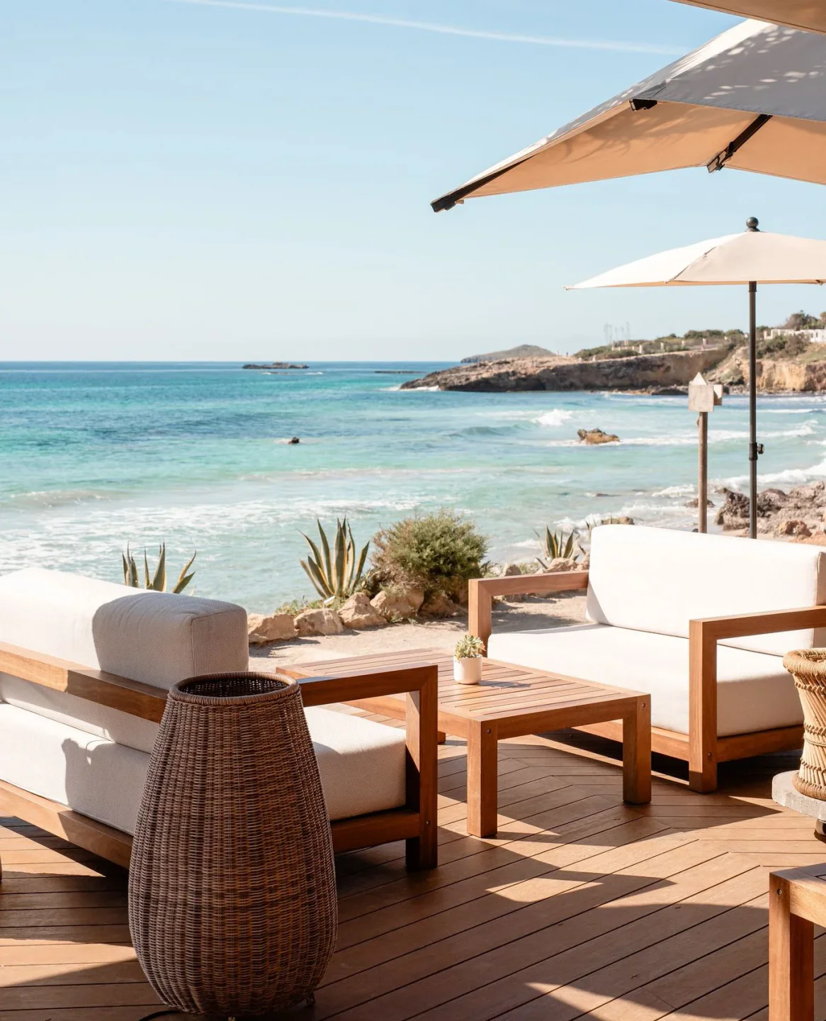 Aiyanna beach club in Ibiza with comfortable seating and ocean views under umbrellas.