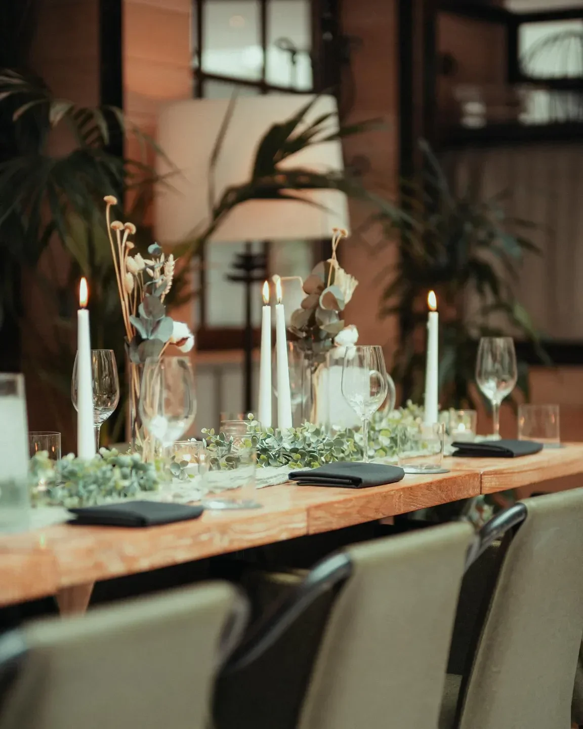 Elegant dining table at Aizle in Edinburgh, with candles and greenery.