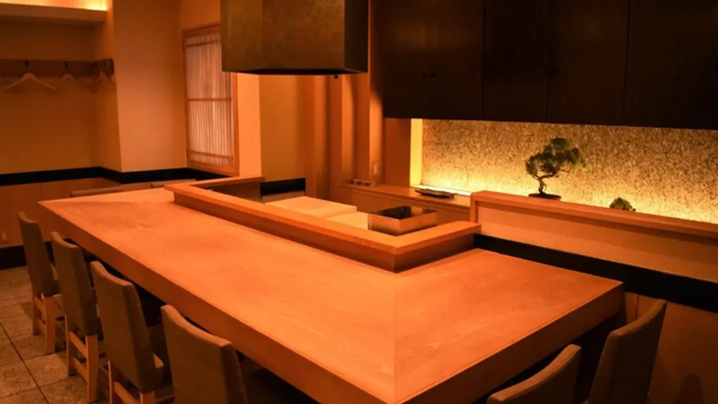 Interior dining space at Akanezaka Onuma restaurant in Tokyo with wooden counter and seating