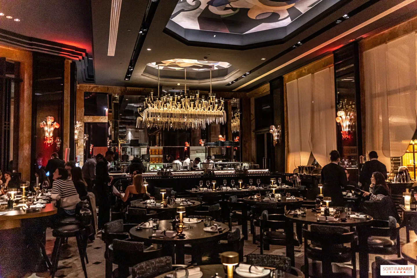 Elegant interior view of Akira Back restaurant in Paris, featuring a stylish chandelier.