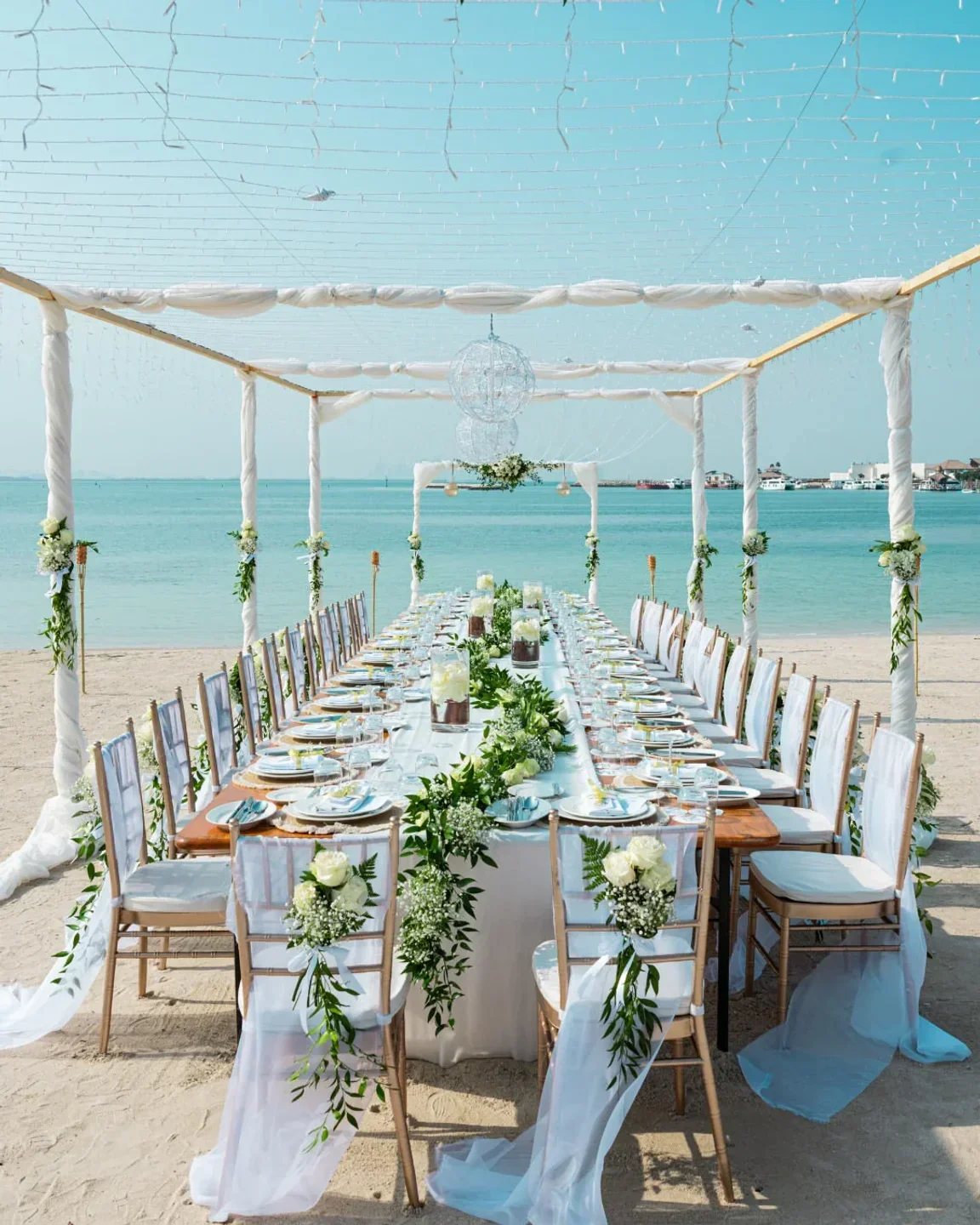 Beachfront dining at Al Nahham Restaurant in Doha, elegant setting with sea views.