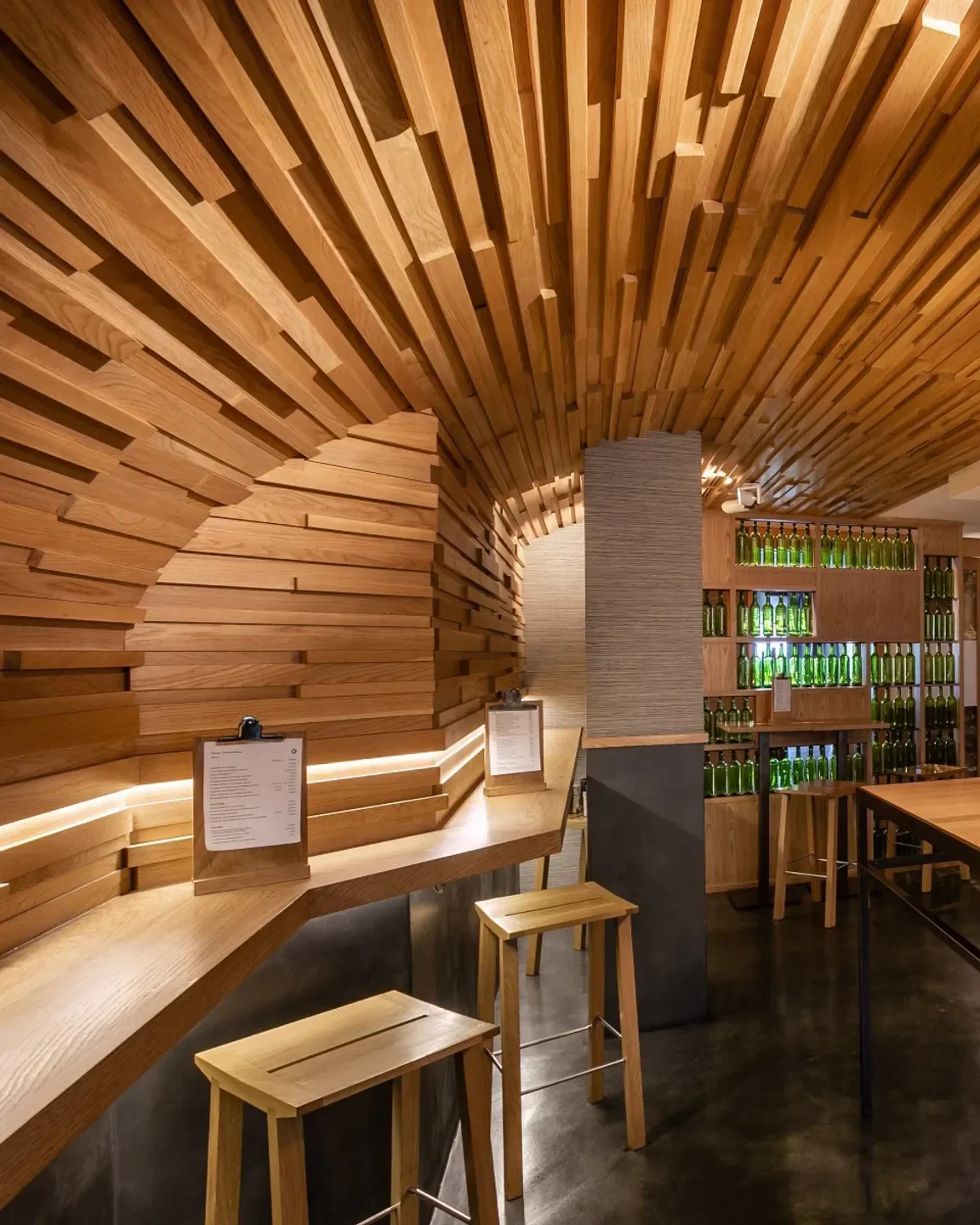 Interior of Alameda restaurant in San Sebastian, featuring unique wooden ceiling design.
