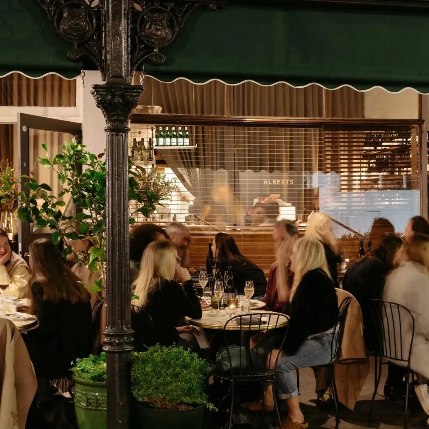 Outdoor dining at Albert's Wine Bar in Melbourne, with tables and people enjoying the evening.
