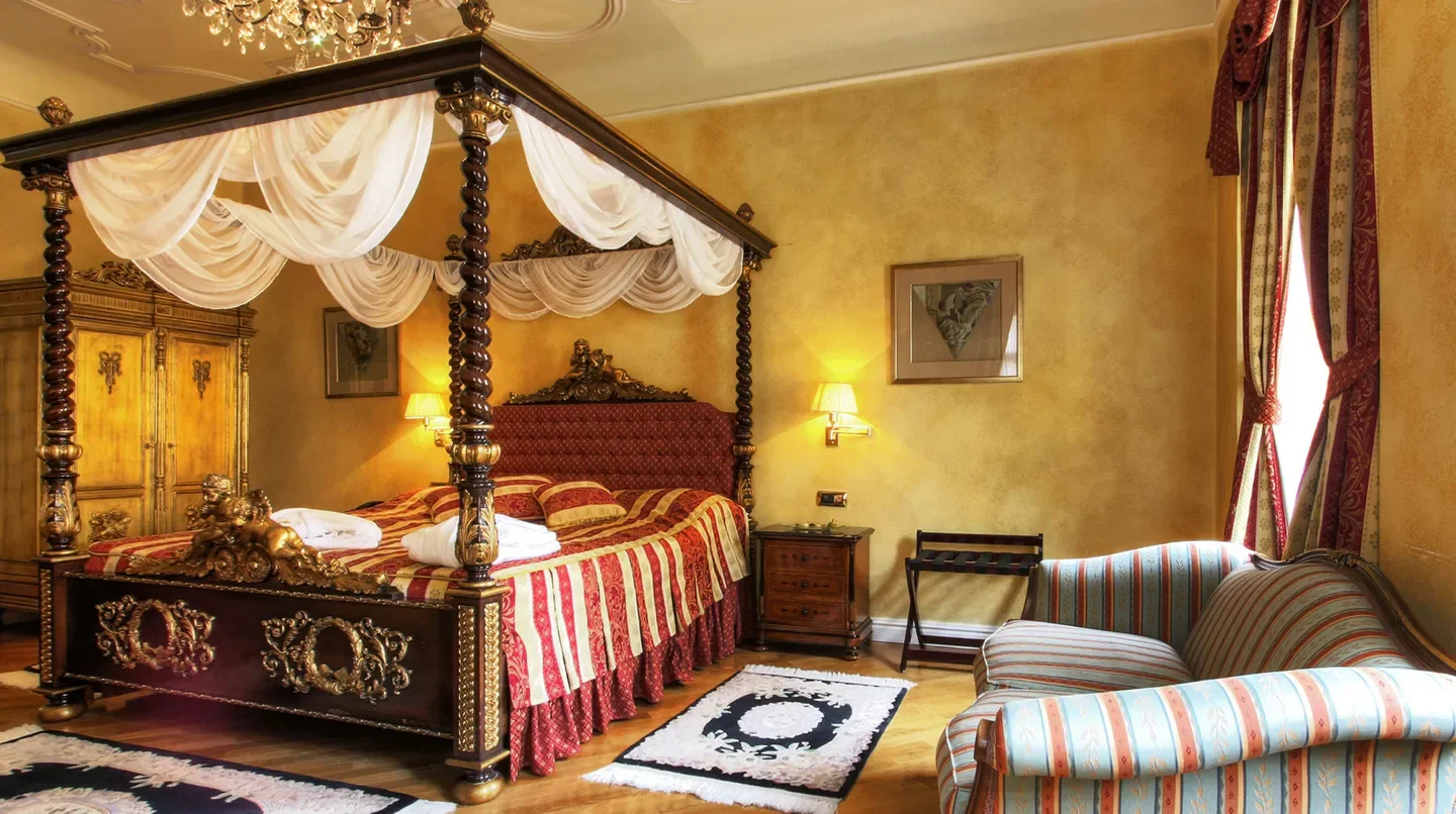 Luxury bedroom at Alchymist Grand Hotel & Spa in Prague with a four-poster bed.