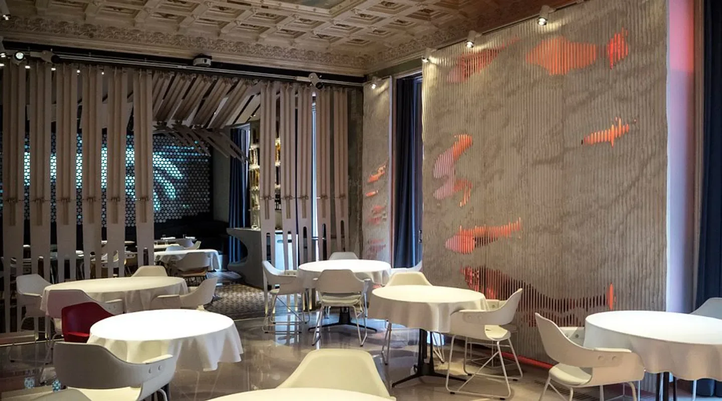Elegant interior of Alkimia restaurant in Barcelona, featuring stylish decor and dining tables.