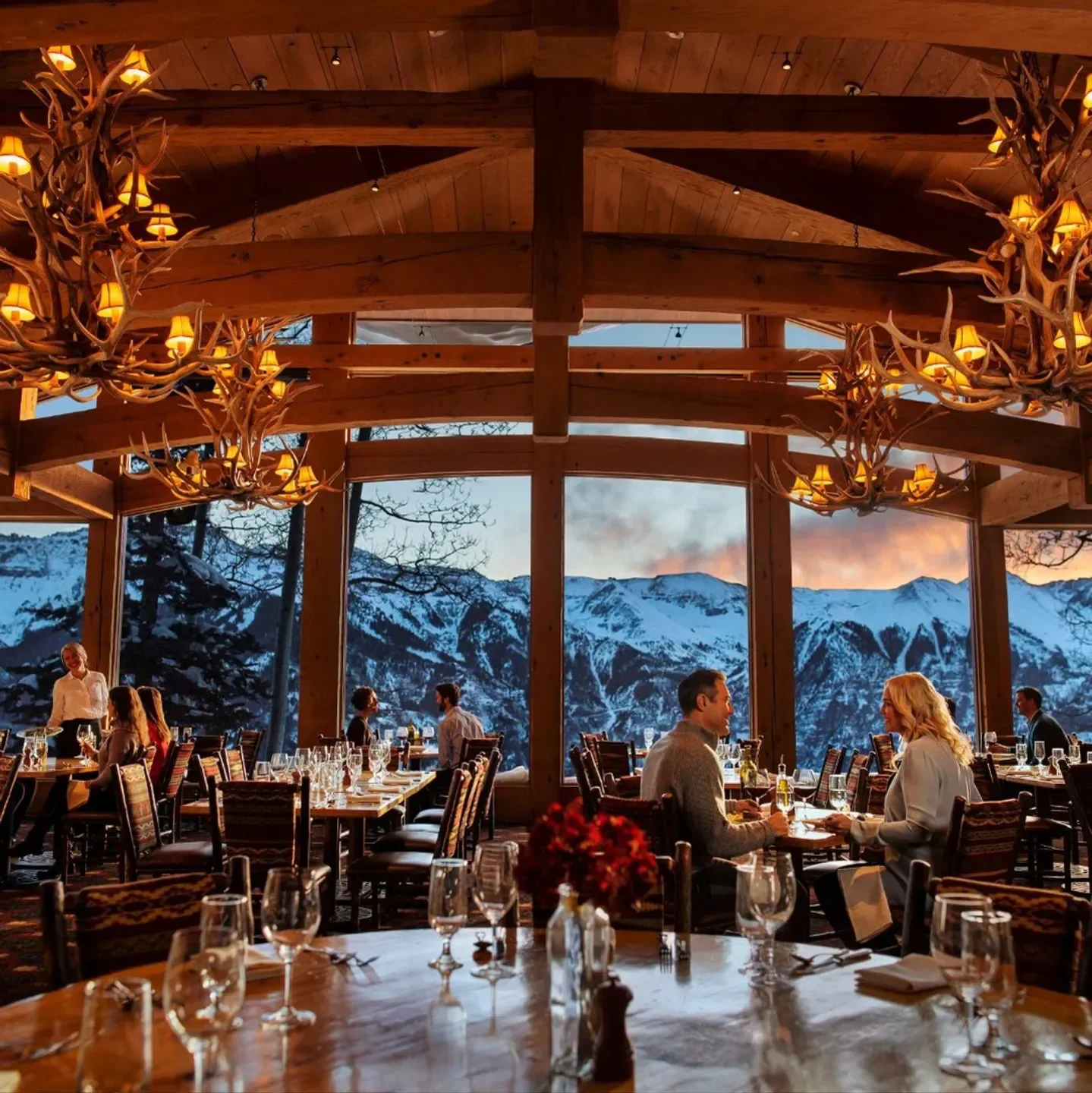 Cozy dining at Allred's Restaurant in Telluride with mountain views and antler chandeliers