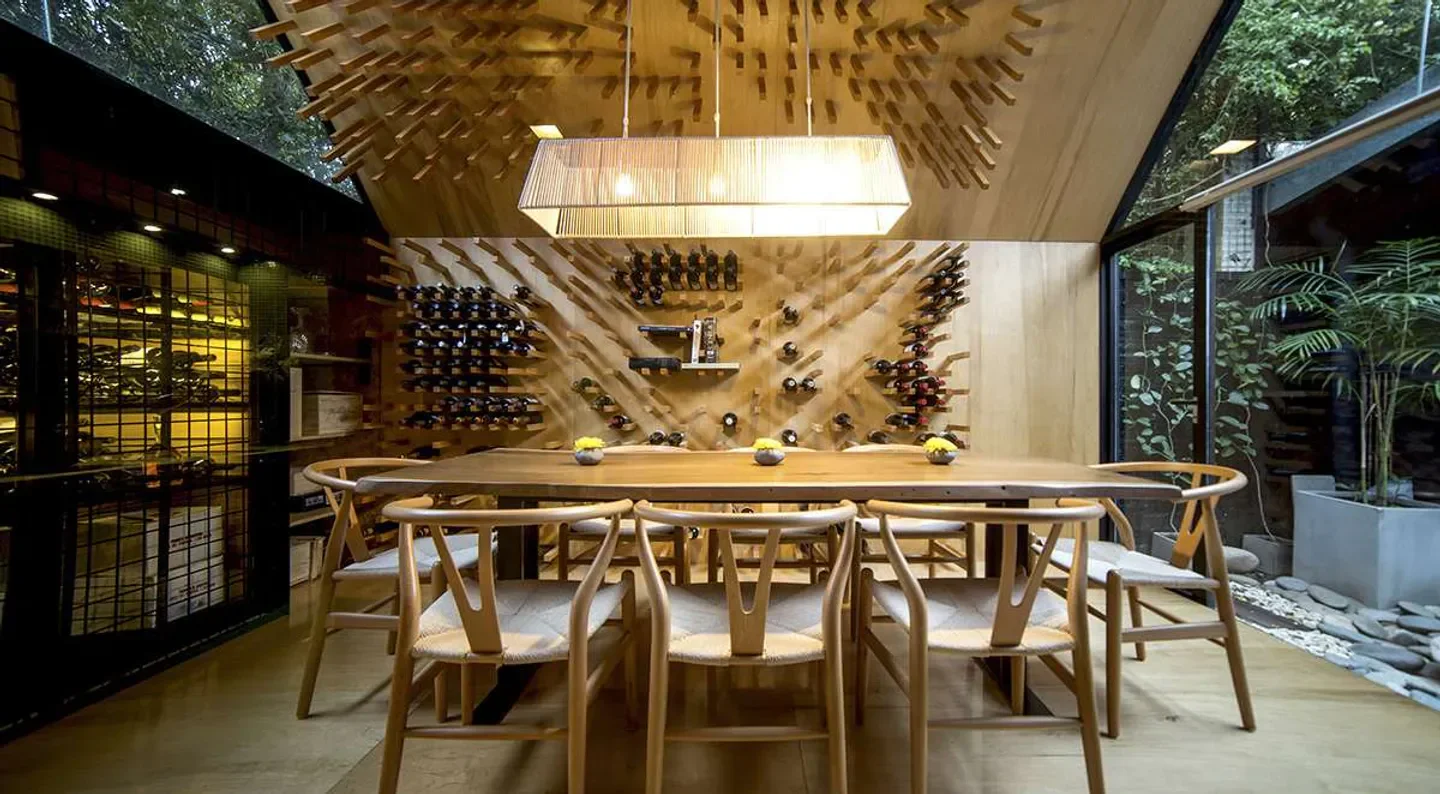 Interior dining at Alo's in Buenos Aires, featuring wine storage and stylish decor