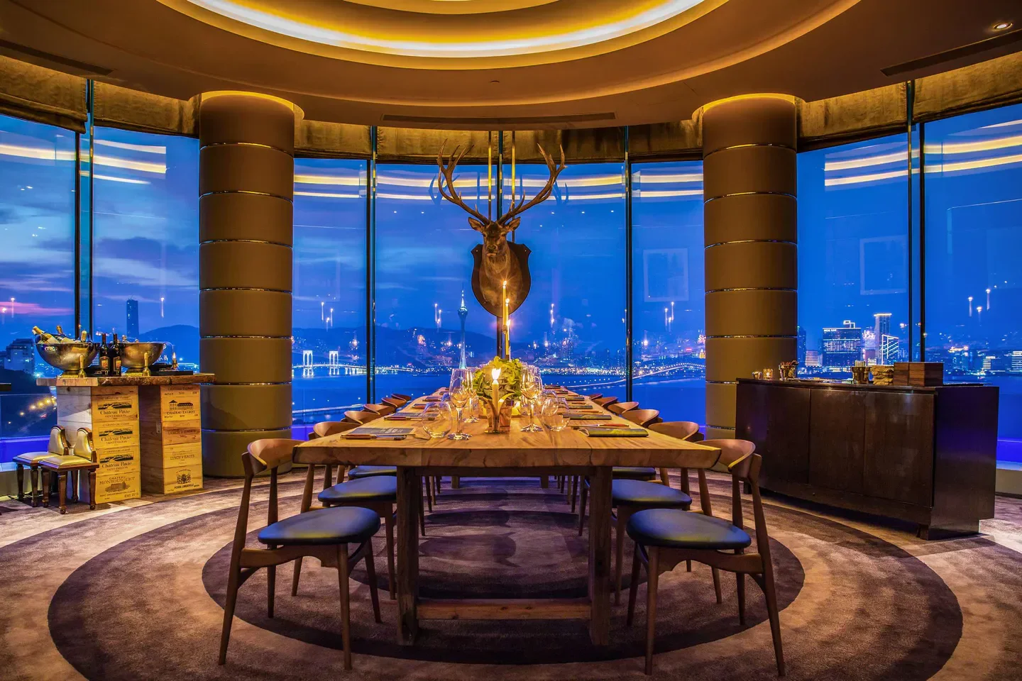 Altira restaurant in Macau with city view, long table set for dinner.