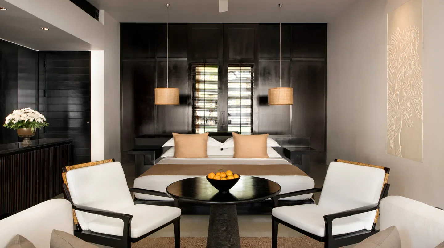 Stylish hotel bedroom at Amansara in Siem Reap with modern decor and ambiance.