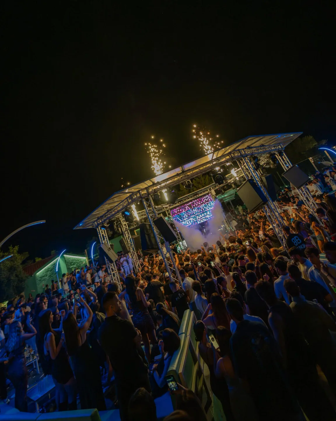 Ambra Night nightclub in Sardinia buzzes with a crowd enjoying fireworks and a lively DJ set.