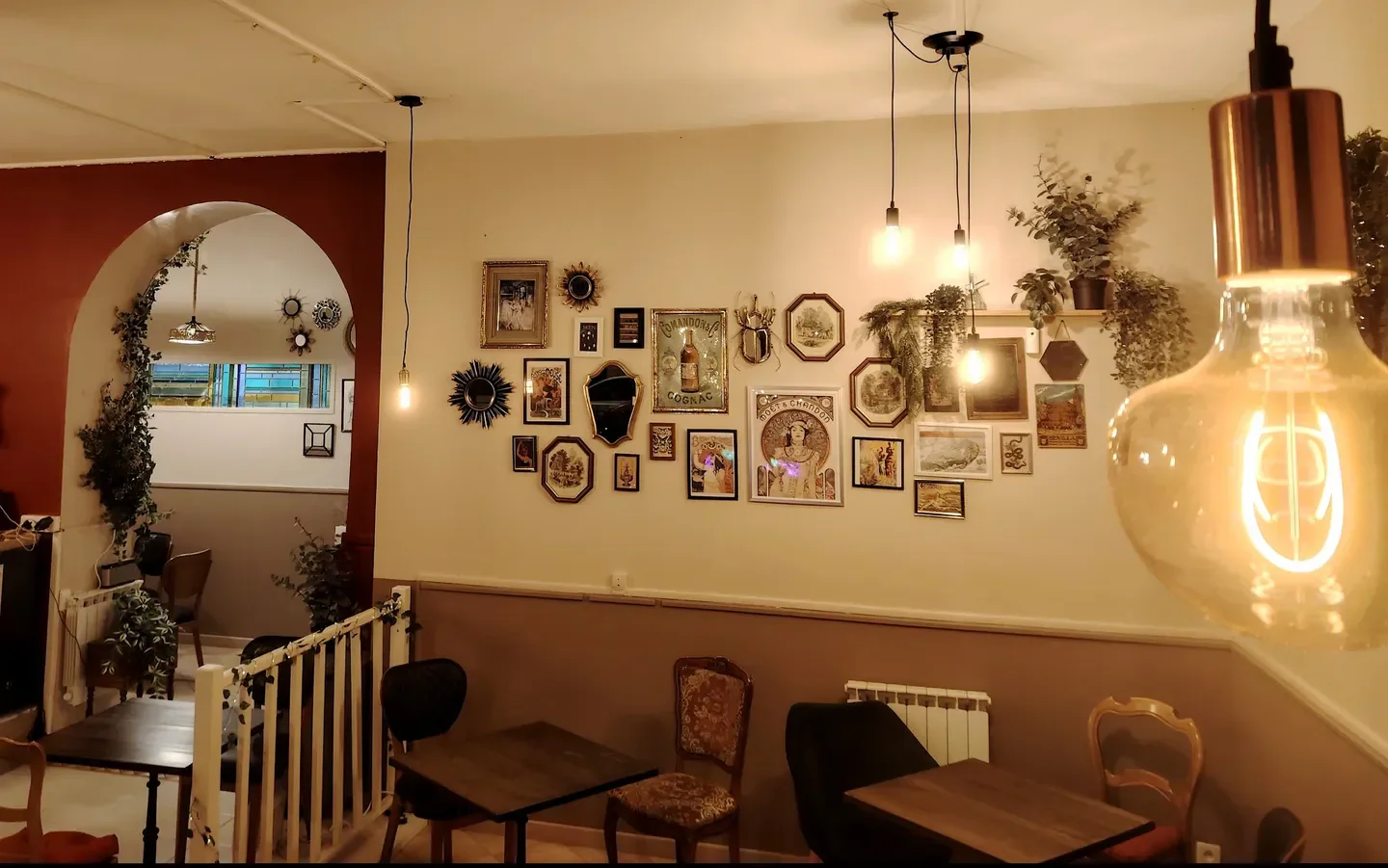 Cozy interior of Ambroisie restaurant in Lyon, featuring vintage decor and warm lighting