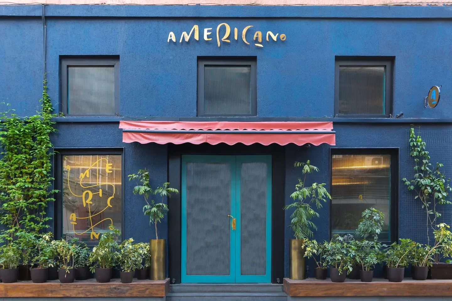 Exterior of Americano restaurant in Mumbai, featuring blue facade and stylish entrance.