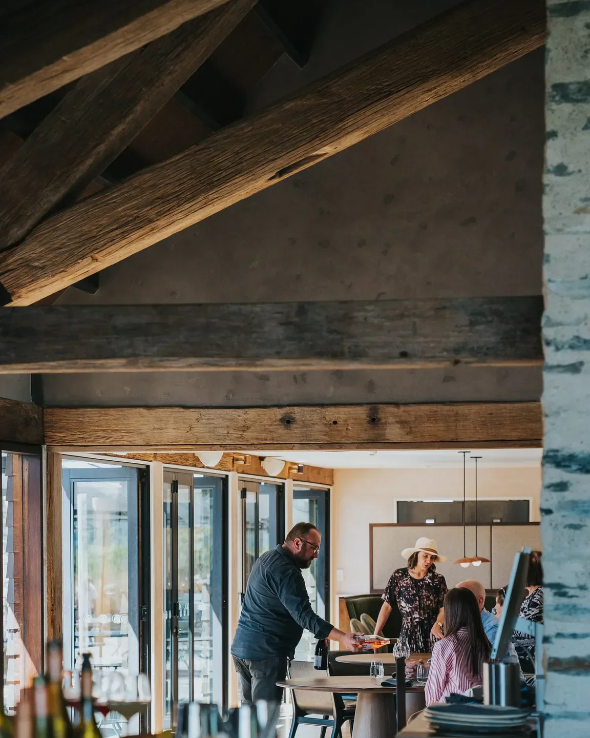 Dining at Amisfield Restaurant in Queenstown with beautiful wooden beams and decor.