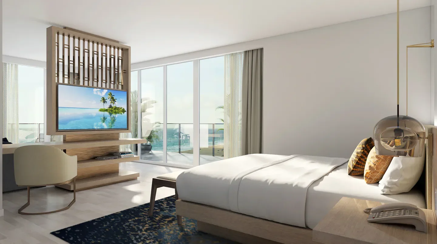 Luxury bedroom at Amrit Ocean Resort & Residences in Palm Beach, with ocean views and TV.
