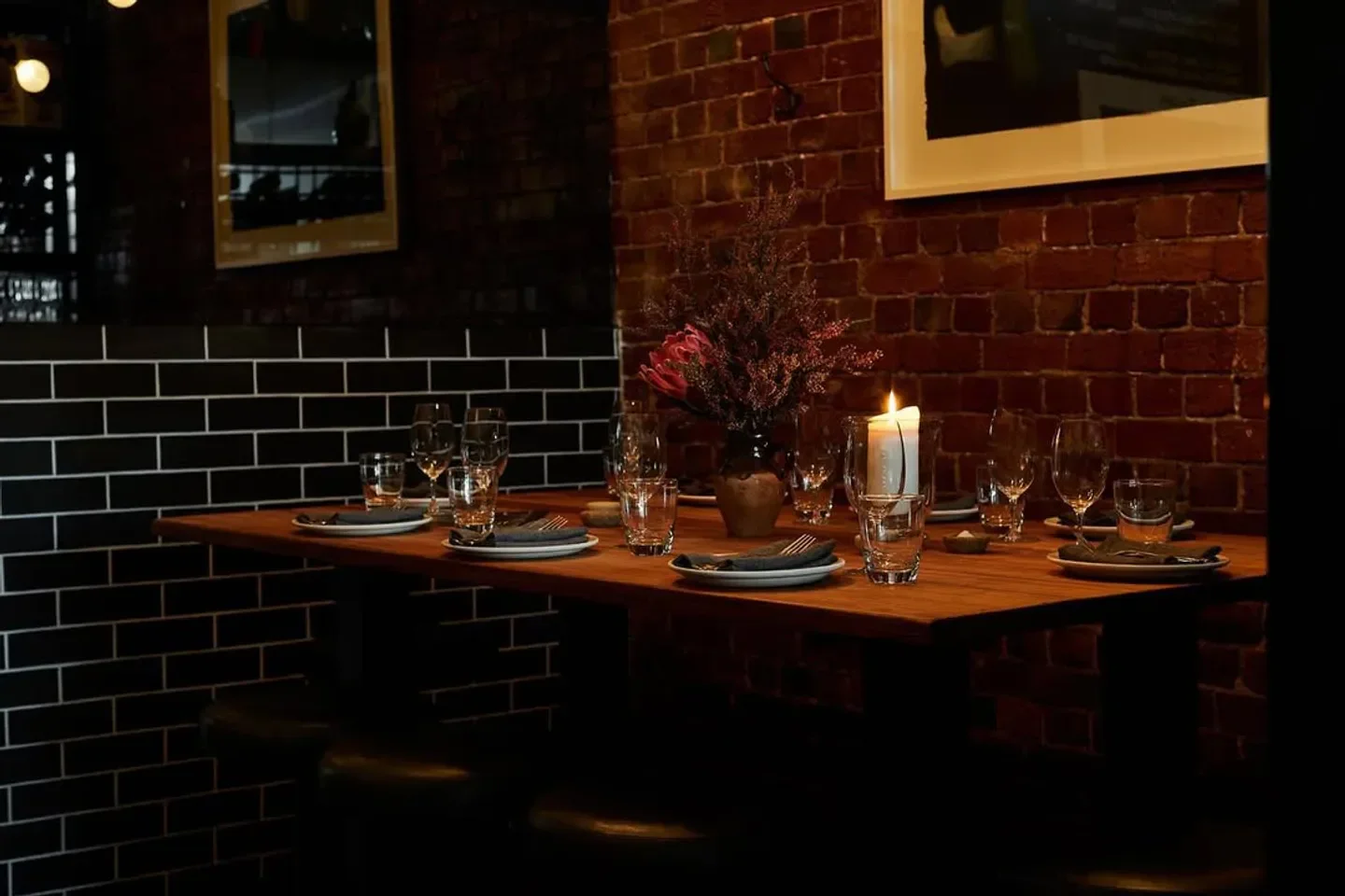 Anada Melbourne's stylish interior with candlelit table setting, perfect for dining.