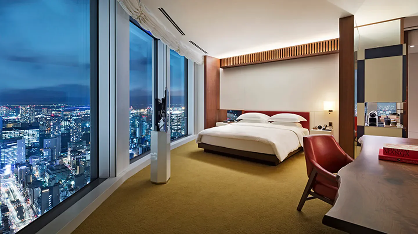 Luxury hotel room with city views at night in Tokyo's Andaz Tokyo Toranomon Hills