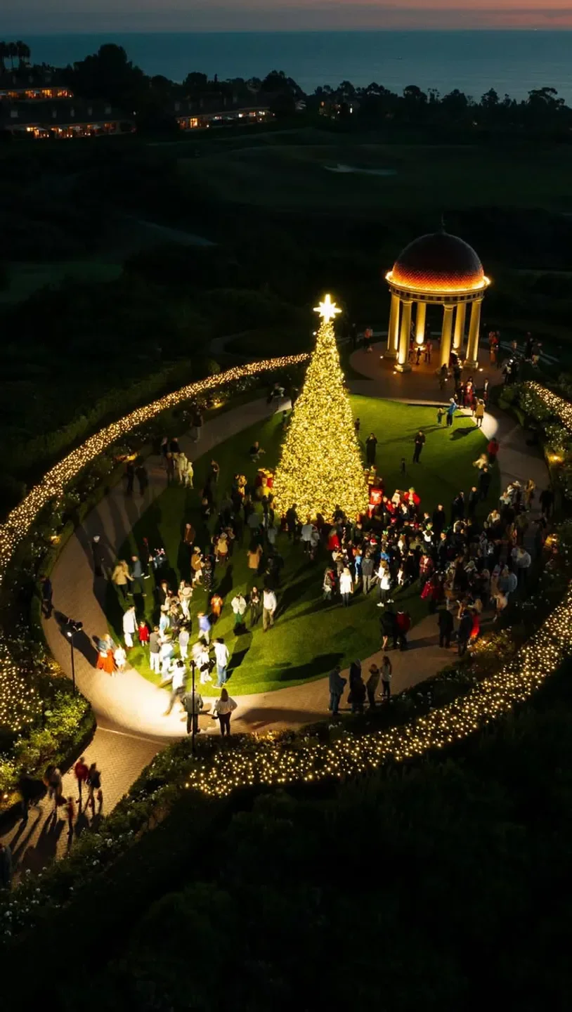 Festive Christmas tree at Andrea in Orange County, surrounded by people and lights.