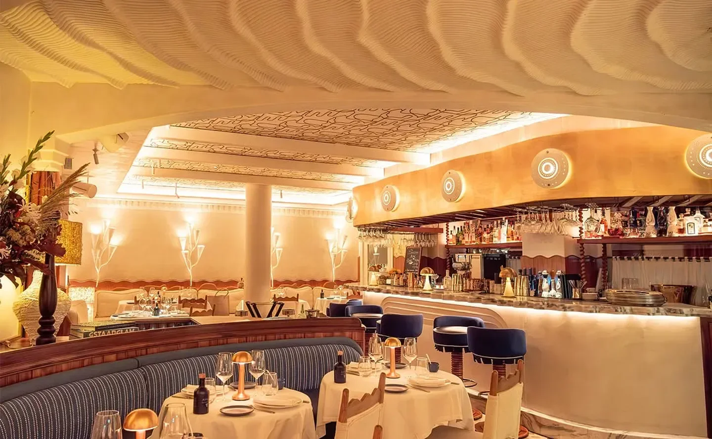 Stylish interior of Anna restaurant in Paris, featuring a unique wavy ceiling design