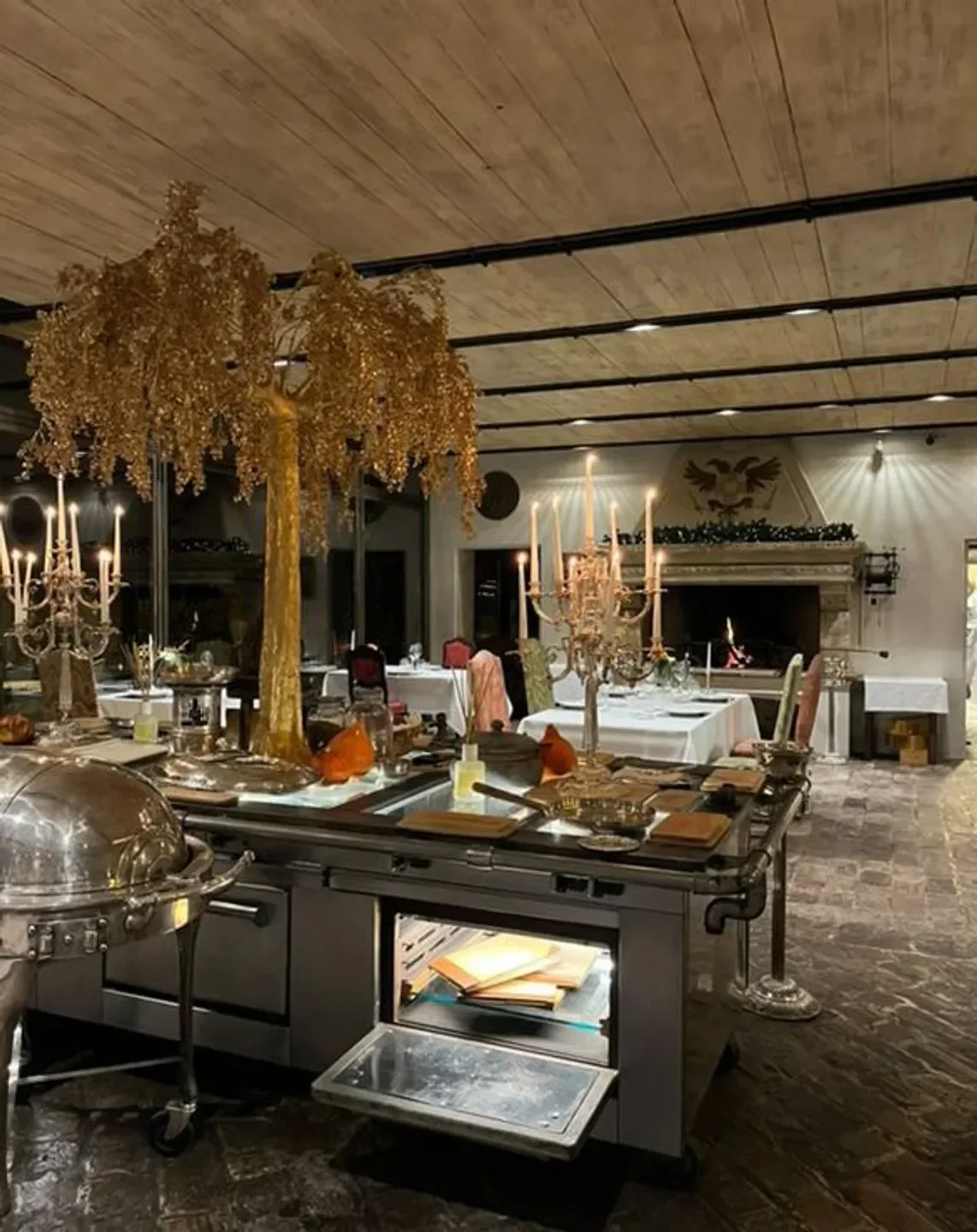 Elegant dining at Antica Corte Pallavicina restaurant, Emilia-Romagna, with golden decor.