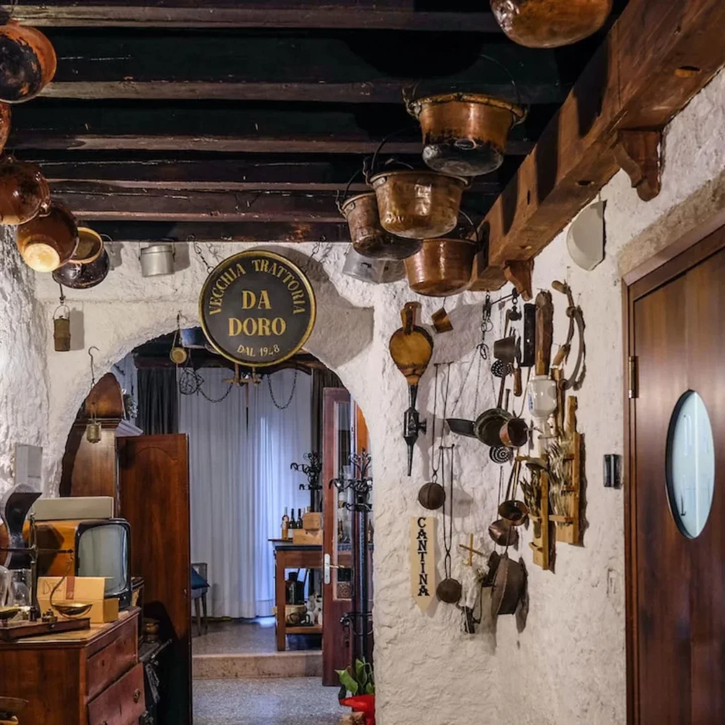 Interior of Antica Trattoria Da Doro in Veneto, Italy. Rustic decor with copper pots and Italian restaurant ambiance.