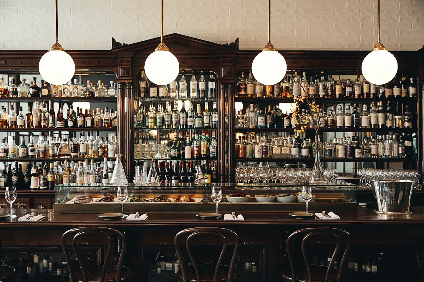 Interior bar at Apoteca in Adelaide, with stylish decor and impressive liquor display.