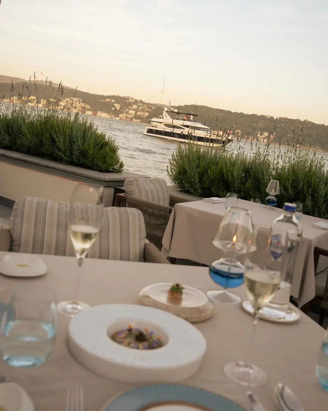 Aqua Restaurant in Istanbul with waterfront dining and a scenic view of a boat.