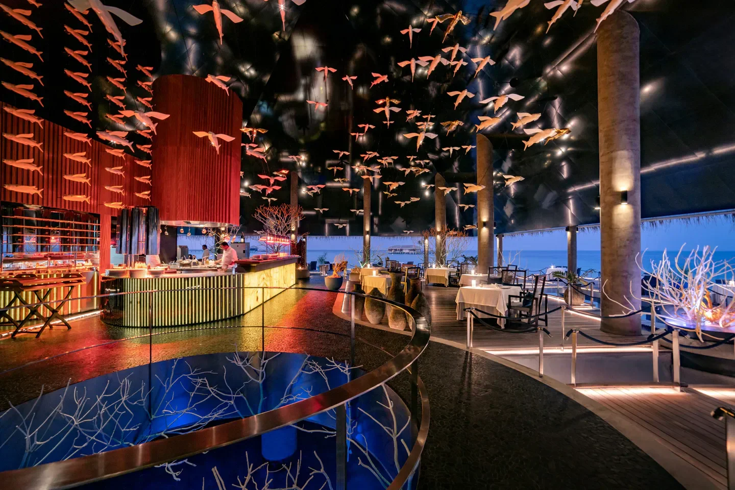 Stunning interior of Aragu restaurant in Maldives, featuring unique fish decor and ocean views