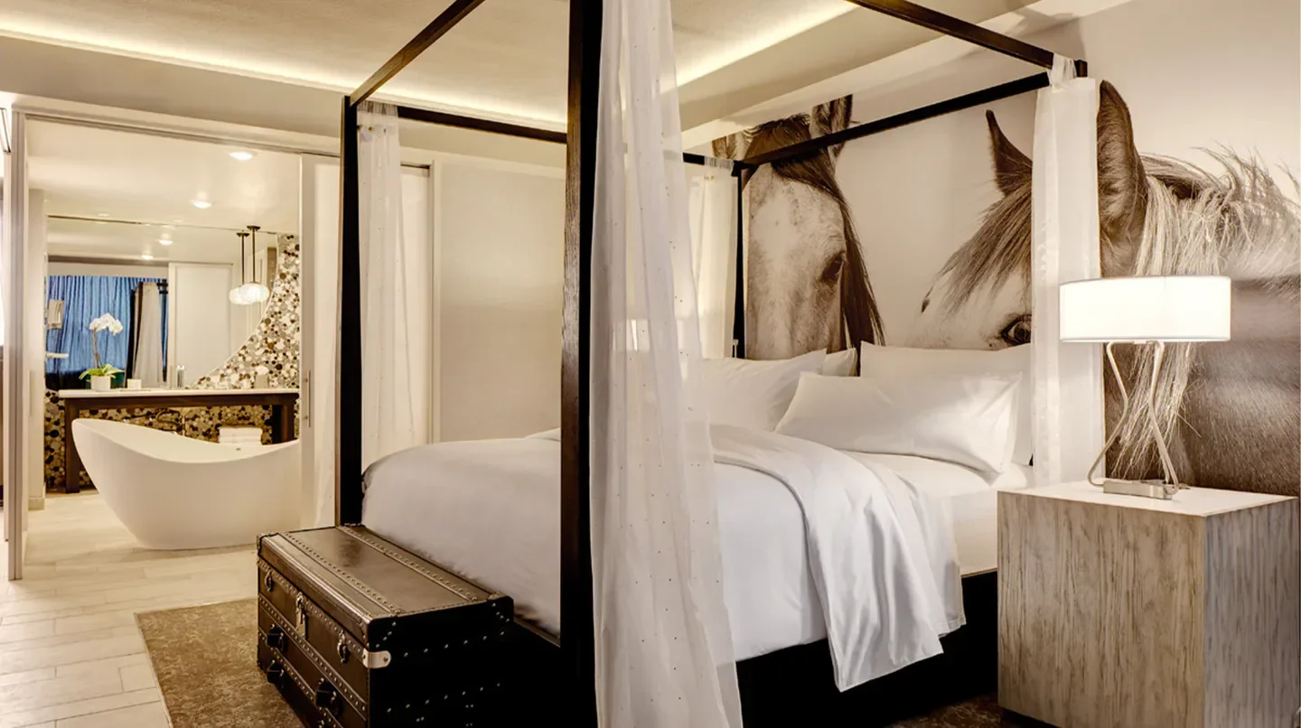 Stylish bedroom at Archer Hotel Austin with horse mural, Austin, and a luxurious bath.