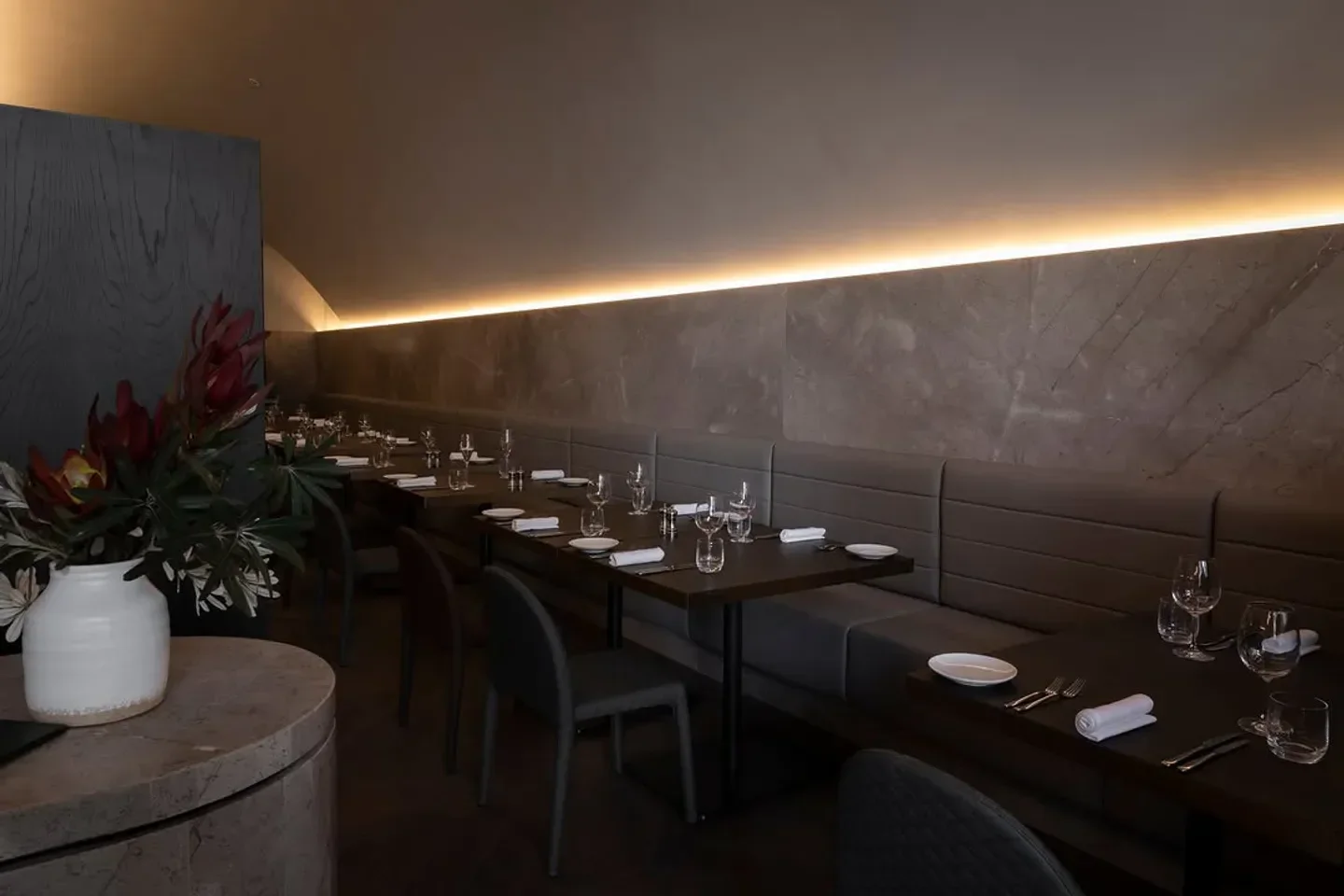 Interior dining at Archer's restaurant in Melbourne, with tables and decorative flowers.