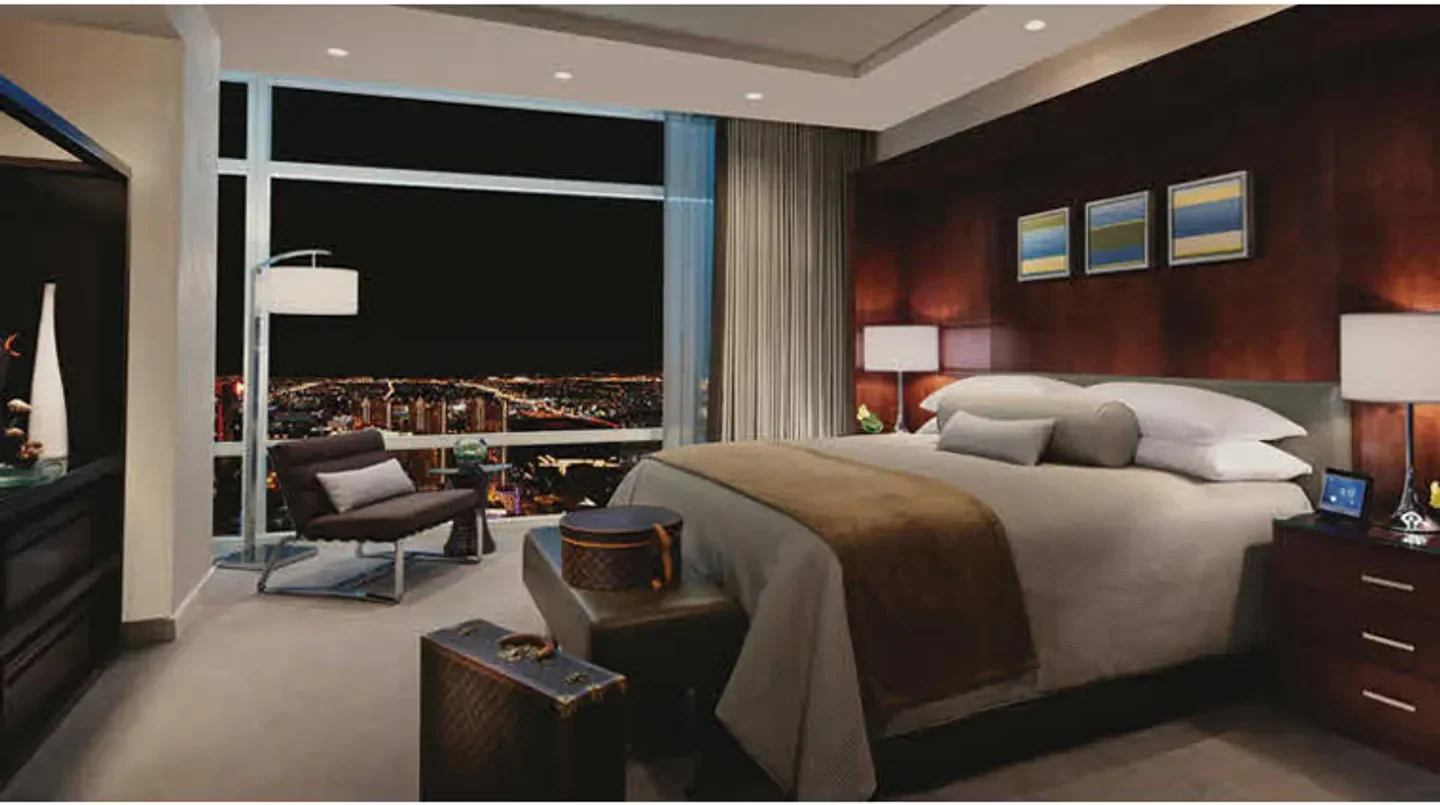 Luxury bedroom at ARIA Resort & Casino in Las Vegas, with city views at night.