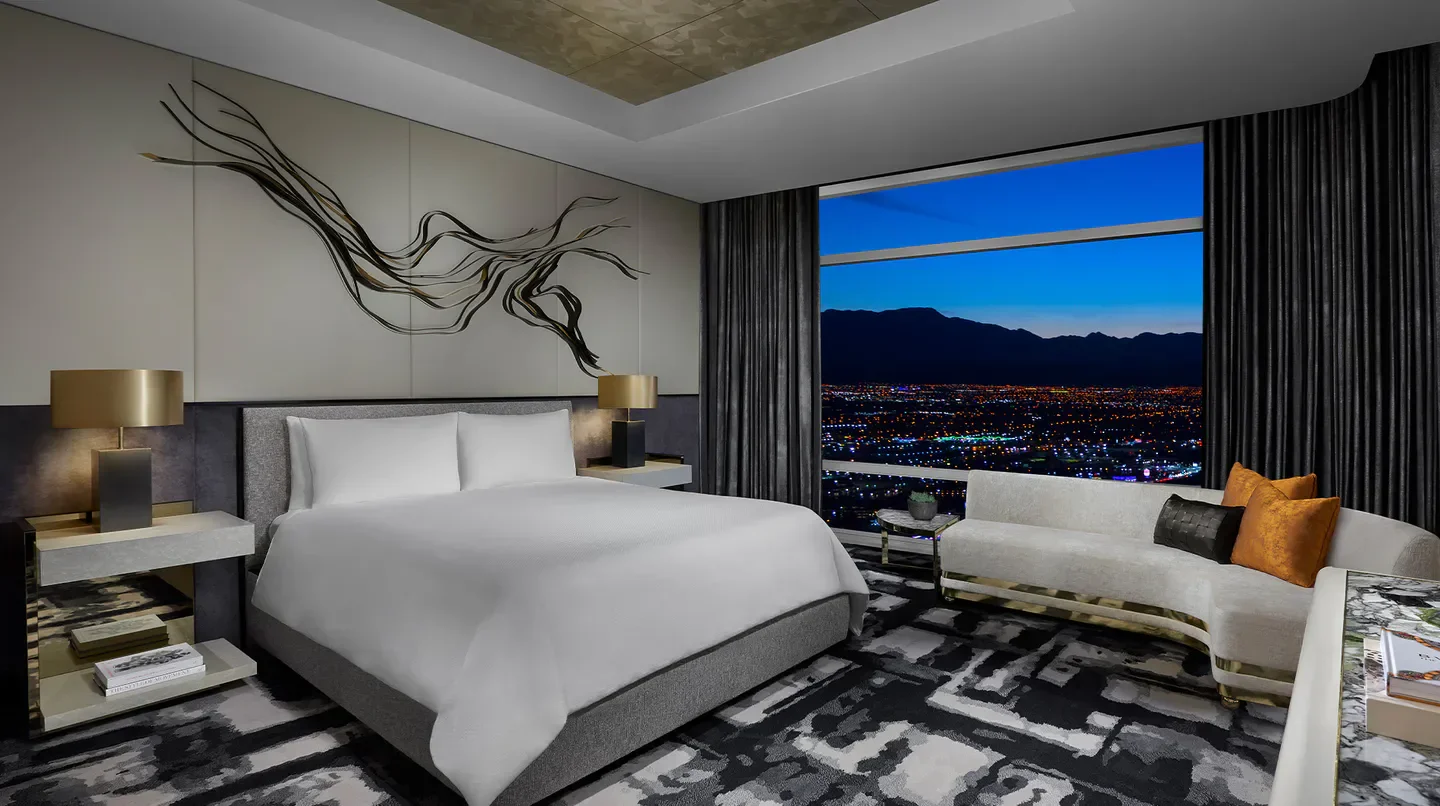 Luxury bedroom at ARIA Sky Suites, Las Vegas, with city views at dusk.