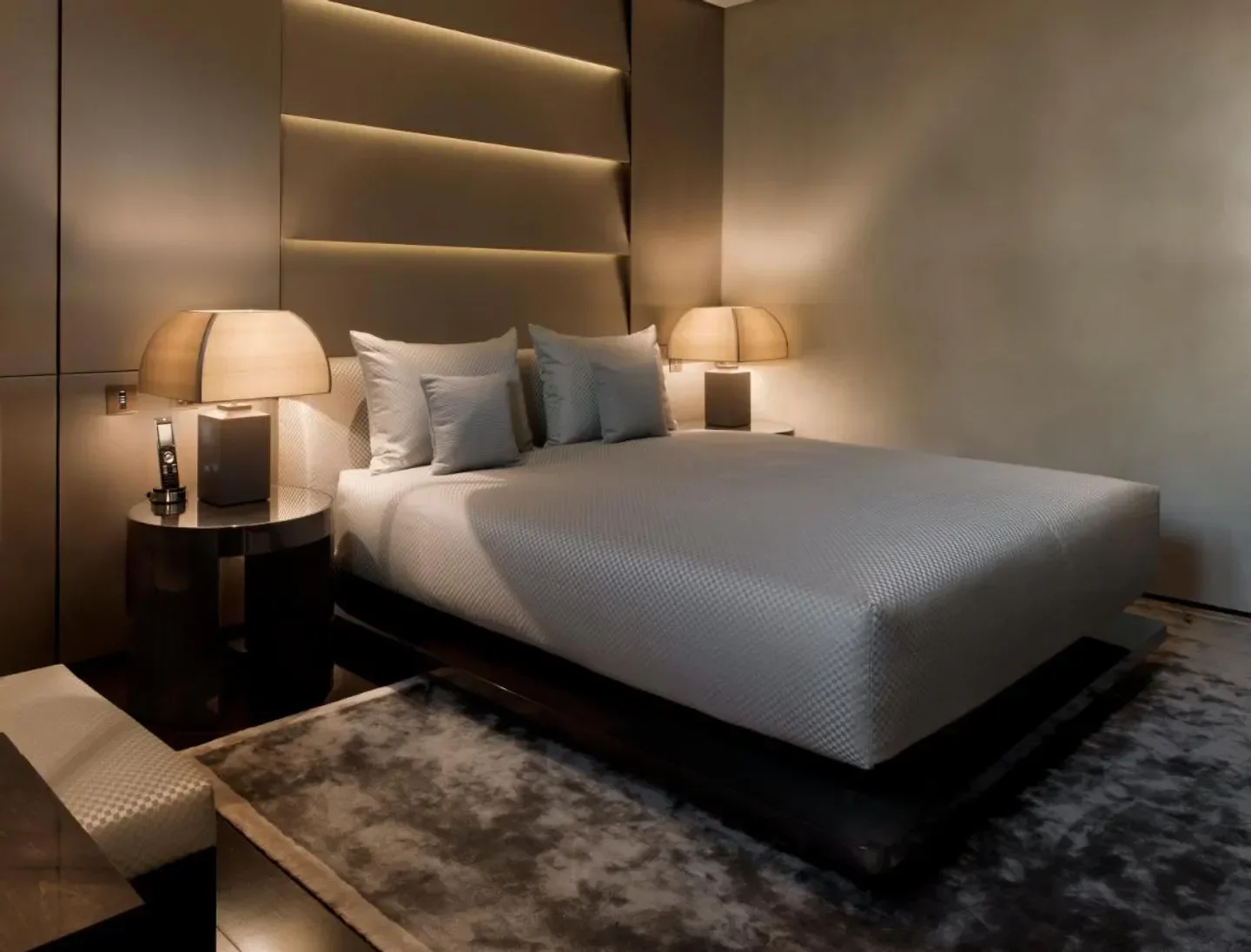 Cozy bedroom interior at Armani Hotel Milano in Milan, featuring stylish lighting and decor