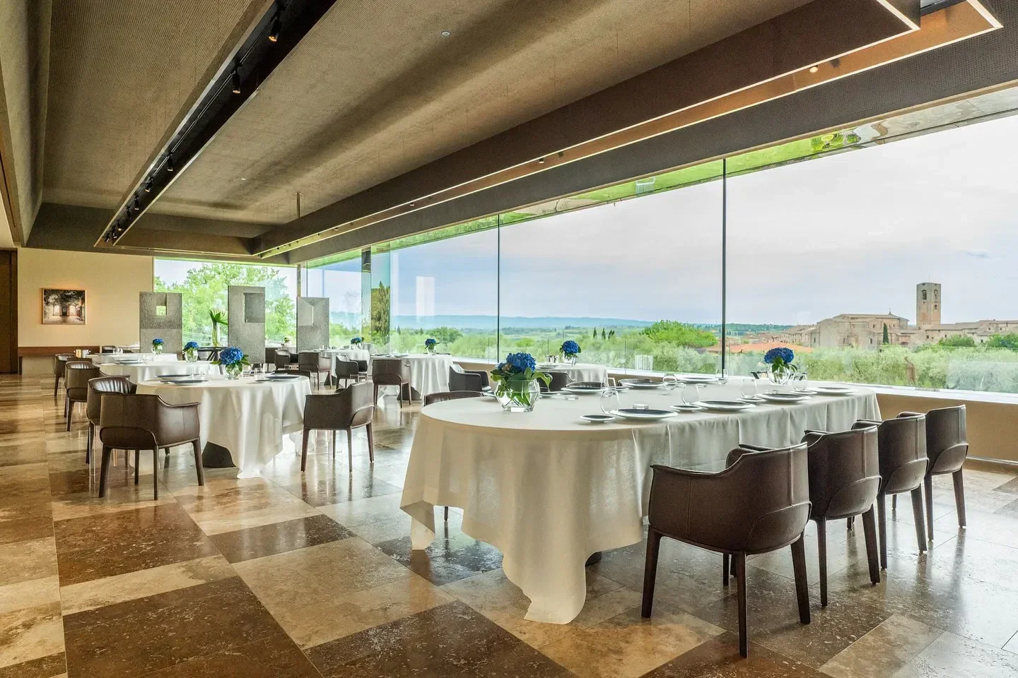 Elegant dining room at Arnolfo restaurant in Tuscany, with scenic views and refined setting.