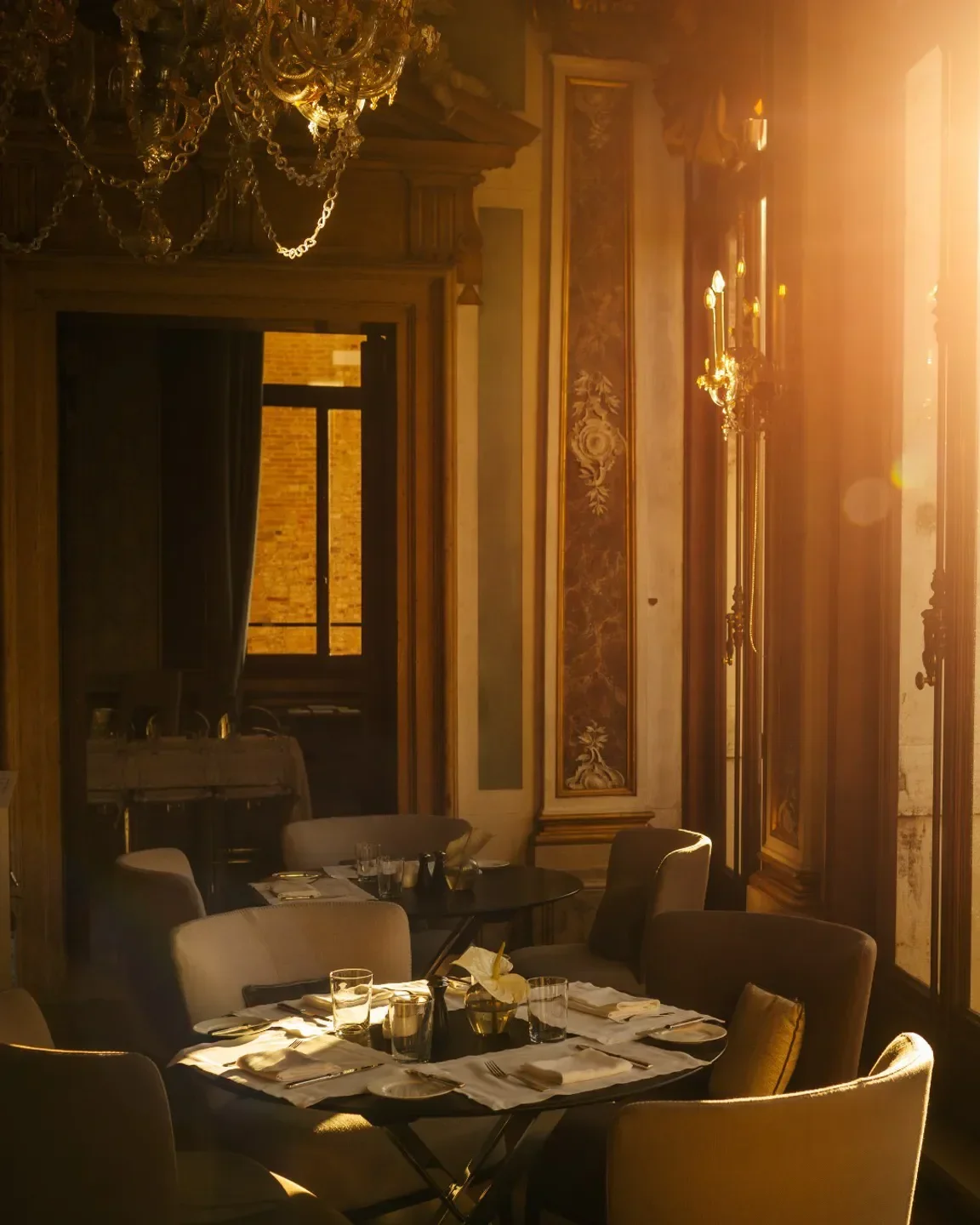 Elegant dining room at Arva restaurant in Venice, bathed in warm sunlight.