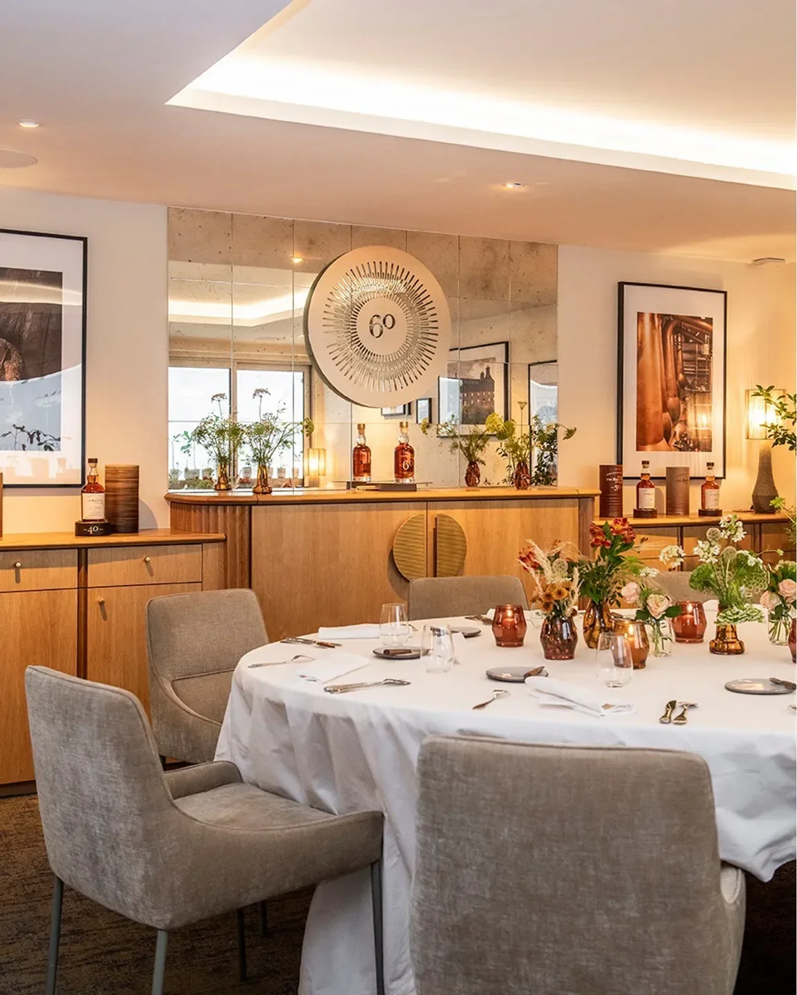 Astrance restaurant in Paris: elegant table setting with floral arrangements and mirror backdrop